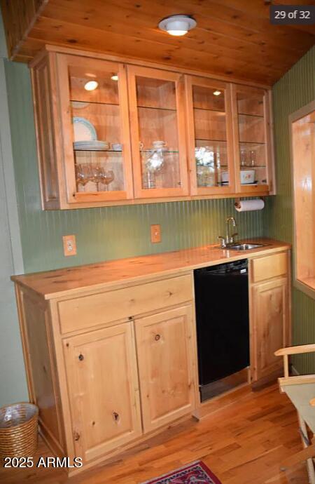 bar with wood ceiling, light hardwood / wood-style floors, dishwasher, and sink