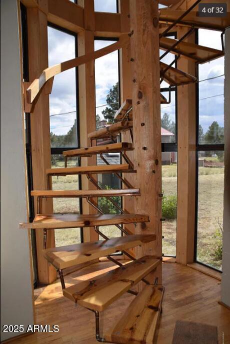 doorway to outside with hardwood / wood-style floors and floor to ceiling windows