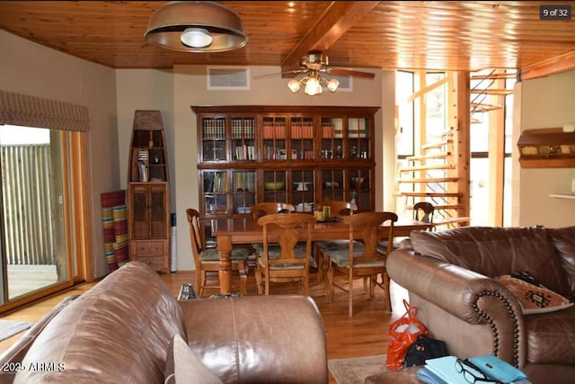 dining room with hardwood / wood-style flooring, beamed ceiling, plenty of natural light, and wooden ceiling