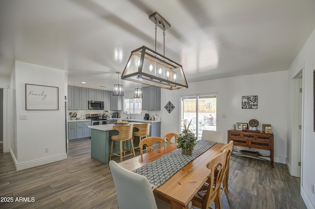 dining area featuring baseboards and dark wood-style flooring