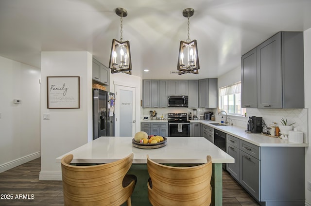 kitchen with black fridge with ice dispenser, a notable chandelier, gray cabinetry, stainless steel microwave, and electric range