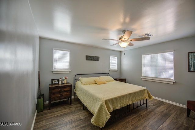bedroom with baseboards, visible vents, wood finished floors, and ceiling fan