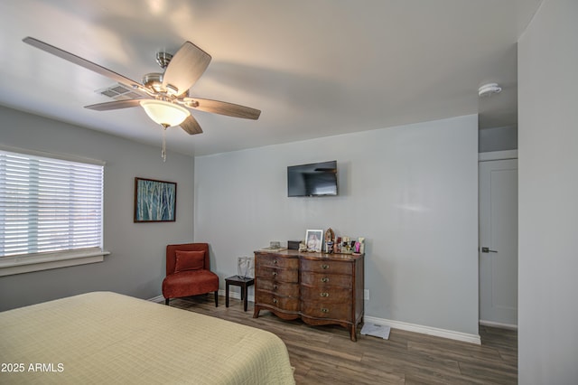 bedroom with baseboards, wood finished floors, and a ceiling fan