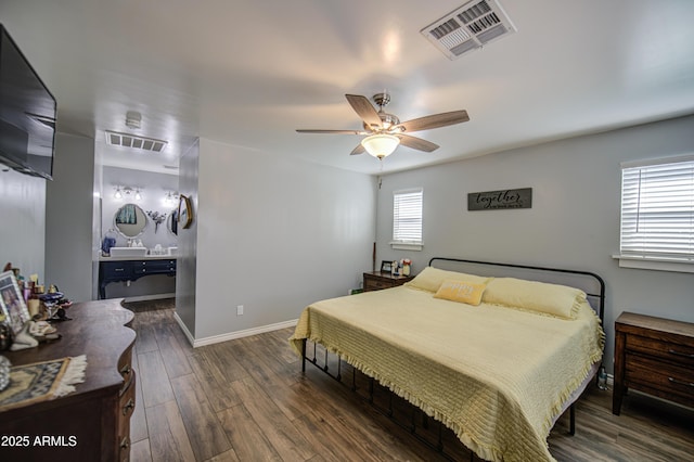 bedroom featuring wood finished floors, baseboards, ceiling fan, and visible vents