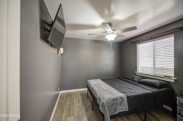 bedroom with billiards, baseboards, ceiling fan, and wood finished floors