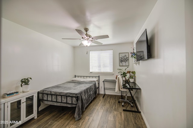 bedroom with baseboards, wood finished floors, and a ceiling fan