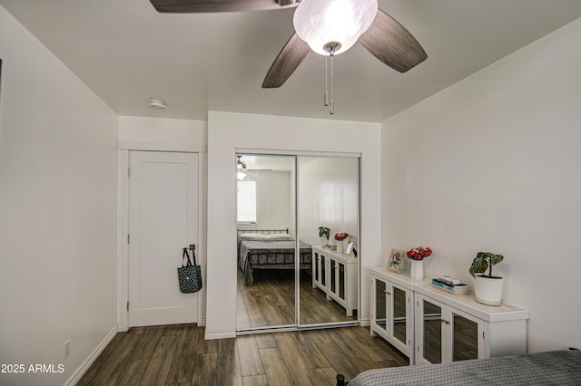 bedroom with a closet, wood finished floors, and a ceiling fan