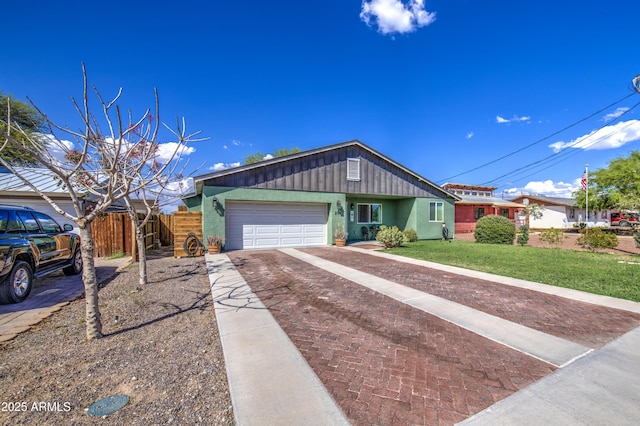 single story home featuring driveway, a front yard, fence, an attached garage, and board and batten siding