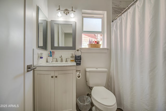 full bath with backsplash, toilet, and vanity