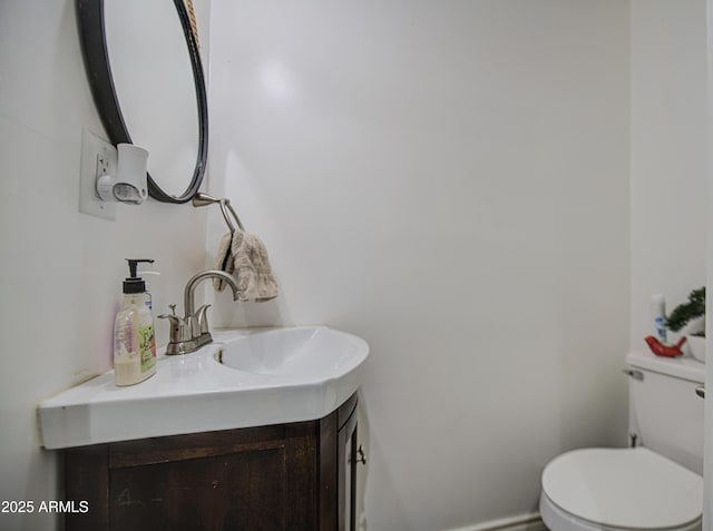 bathroom featuring toilet and vanity