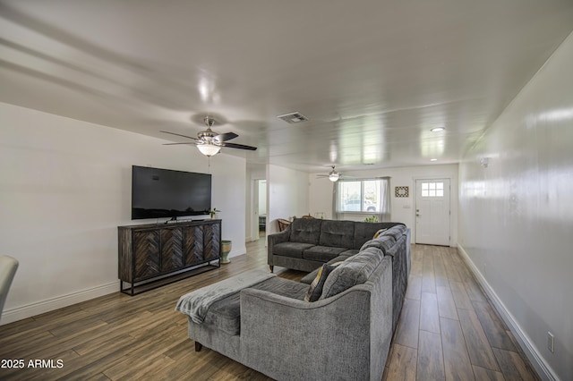 living room featuring a ceiling fan, wood finished floors, baseboards, and visible vents