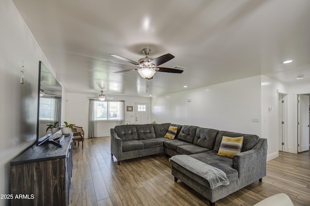 living room with a ceiling fan, wood finished floors, baseboards, visible vents, and recessed lighting