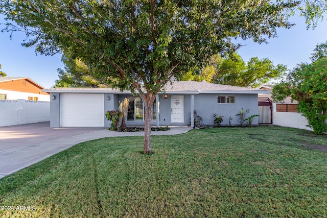 single story home with a front yard and a garage