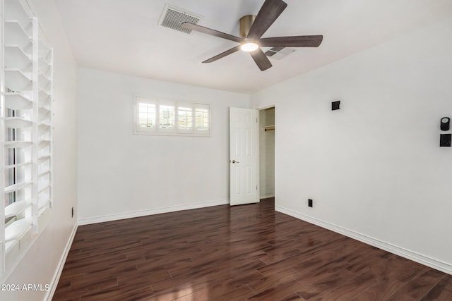 unfurnished room featuring dark hardwood / wood-style floors and ceiling fan