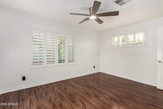 spare room with ceiling fan and dark hardwood / wood-style floors