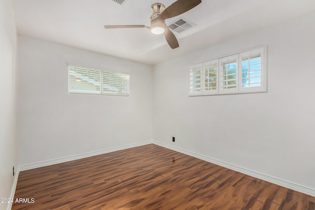 spare room with ceiling fan, dark hardwood / wood-style floors, and a healthy amount of sunlight