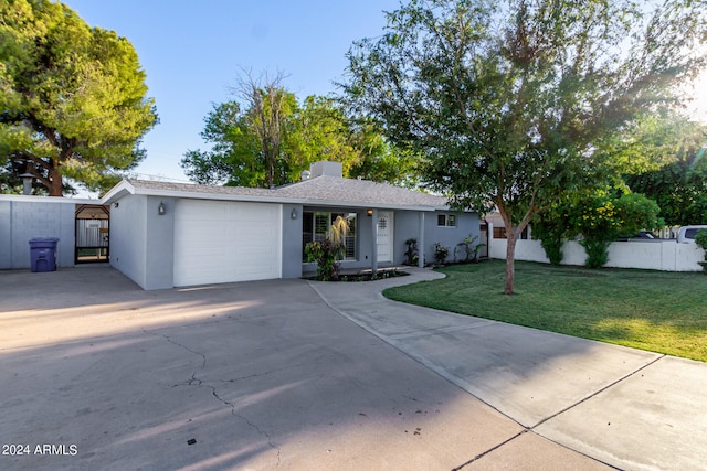 single story home with a garage and a front lawn