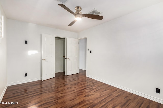 unfurnished bedroom featuring ceiling fan, a closet, and dark hardwood / wood-style floors