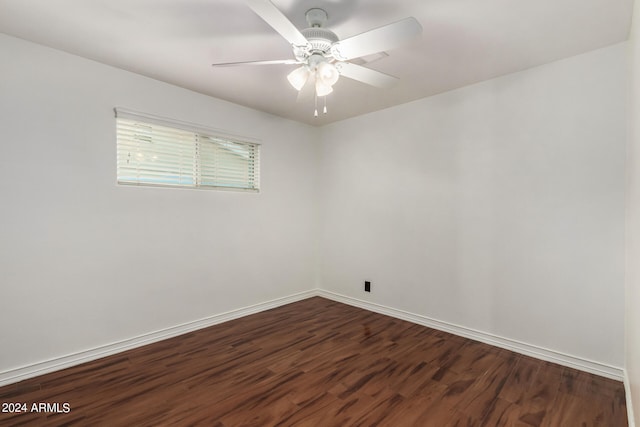 spare room featuring ceiling fan and dark hardwood / wood-style flooring