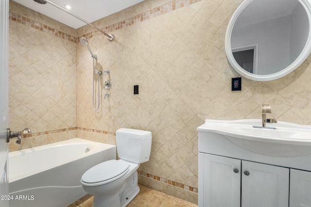 full bathroom featuring tile walls, vanity, toilet, and tiled shower / bath