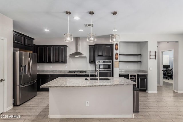 kitchen with appliances with stainless steel finishes, wall chimney range hood, visible vents, and wood tiled floor