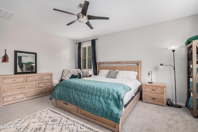 carpeted bedroom with visible vents and ceiling fan