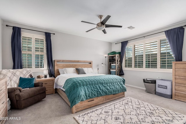 carpeted bedroom featuring baseboards, visible vents, and ceiling fan