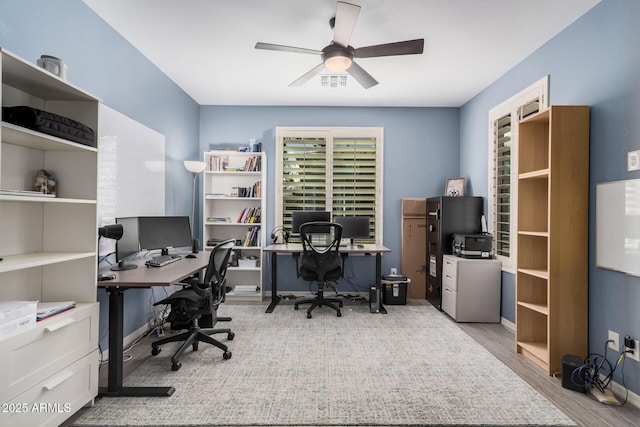 office with visible vents, ceiling fan, and wood finished floors