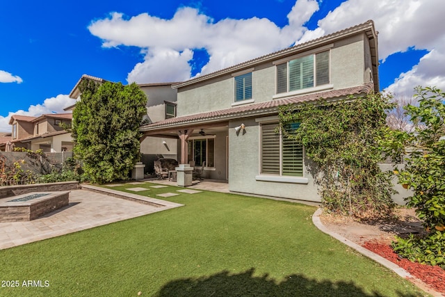 back of property with a patio area, fence, a fire pit, and stucco siding