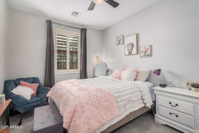 carpeted bedroom featuring visible vents and a ceiling fan