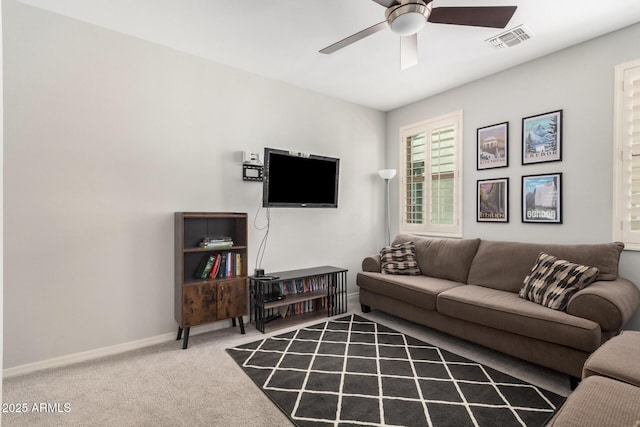 living area featuring a ceiling fan, carpet, visible vents, and baseboards