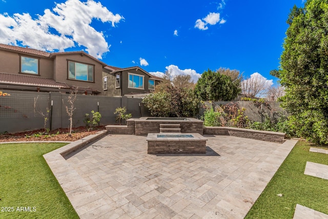 view of patio / terrace featuring a fenced backyard and a jacuzzi