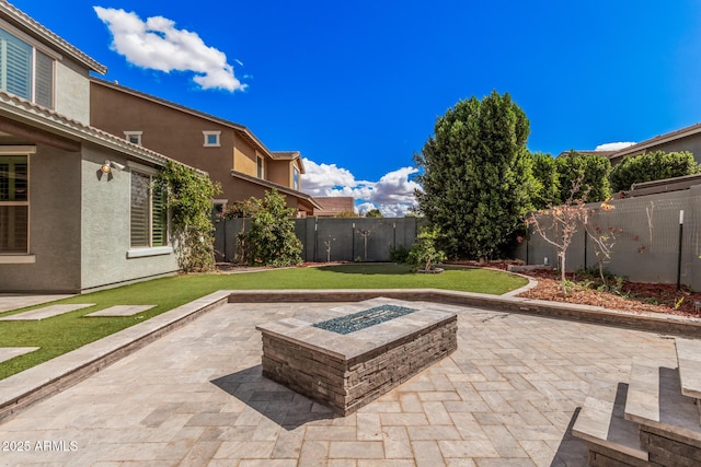 view of patio / terrace with a fire pit and a fenced backyard