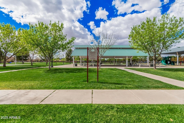 view of home's community featuring playground community and a yard