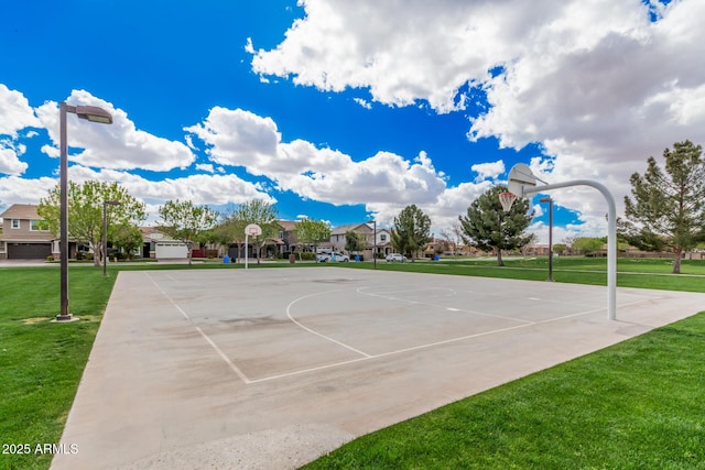 view of basketball court with community basketball court and a yard