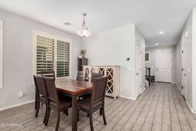 dining space with light wood-type flooring, visible vents, baseboards, and recessed lighting