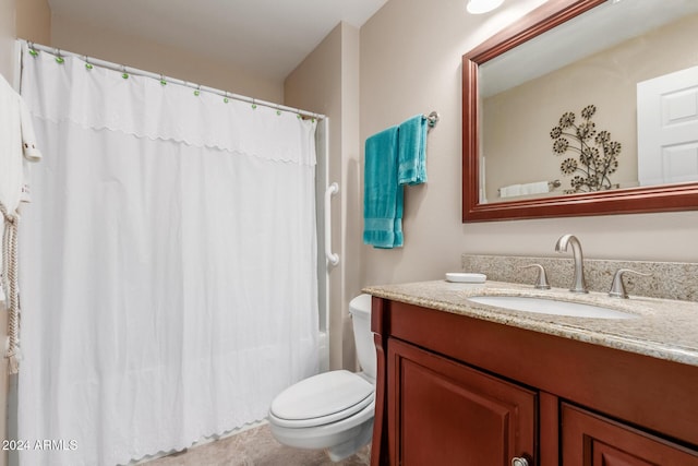 bathroom with curtained shower, vanity, and toilet