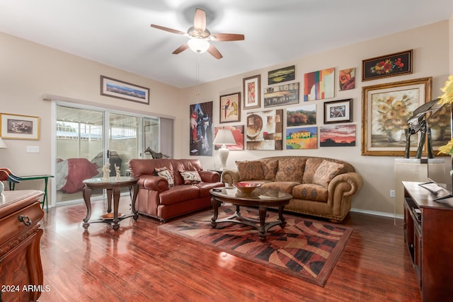 living room with ceiling fan and dark hardwood / wood-style floors