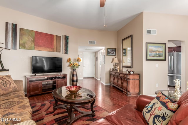 living room with ceiling fan and dark wood-type flooring