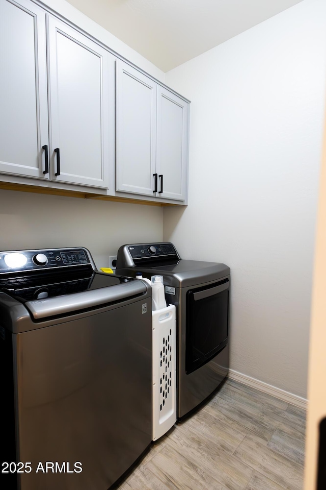 1364 W Spine Tree Ave, Queen Creek, AZ 85140 - laundry room featuring cabinet space, separate washer and dryer, baseboards, and light wood-style flooring