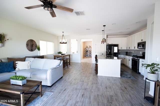 1364 W Spine Tree Ave, Queen Creek, AZ 85140 - living area featuring dark wood finished floors and a ceiling fan