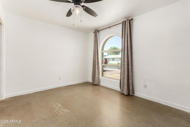 empty room with concrete floors and ceiling fan