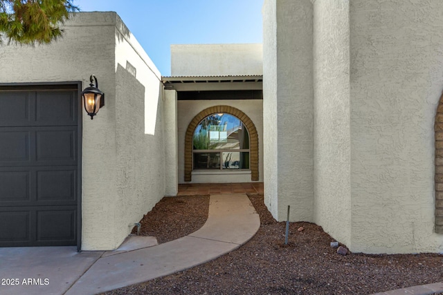 view of exterior entry with a garage