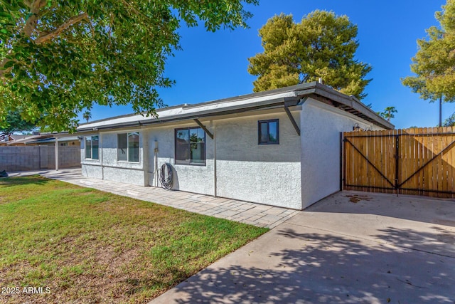 exterior space with a patio and a yard