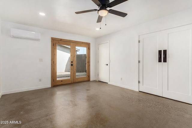 interior space with ceiling fan, concrete floors, french doors, and a wall mounted AC