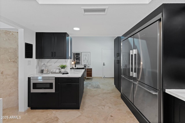 1509 W Kiowa Ave, Mesa, AZ 85202 - kitchen featuring stainless steel appliances, dark cabinets, and light countertops