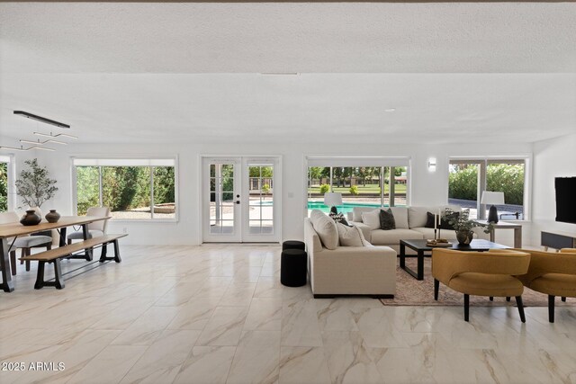 1509 W Kiowa Ave, Mesa, AZ 85202 - living room featuring light marble finish flooring, french doors, and a textured ceiling