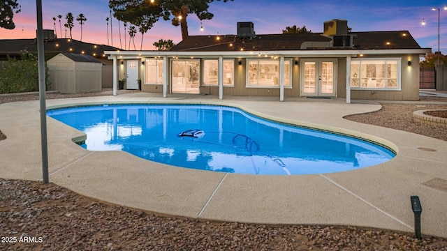 1509 W Kiowa Ave, Mesa, AZ 85202 - view of swimming pool with french doors, a patio area, and a storage unit