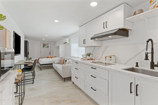 1509 W Kiowa Ave, Mesa, AZ 85202 - kitchen with under cabinet range hood, electric stovetop, recessed lighting, white cabinets, and light marble finish flooring