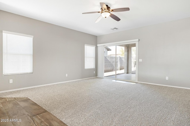 spare room featuring carpet floors and ceiling fan